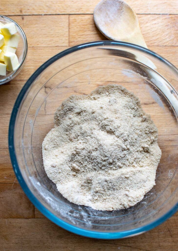 Brown sugar and flour mixed together in a mixing bowl.