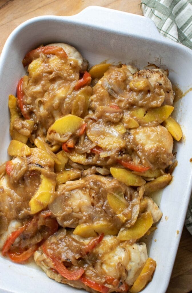 Peach chicken in a ceramic casserole dish.