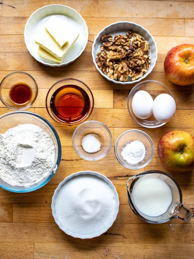 Ingredients to make an apple and walnut cake with maple syrup.