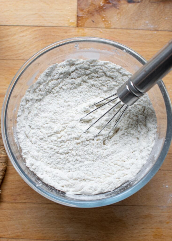 Flour, baking powder and salt whisked together in a glass bowl.