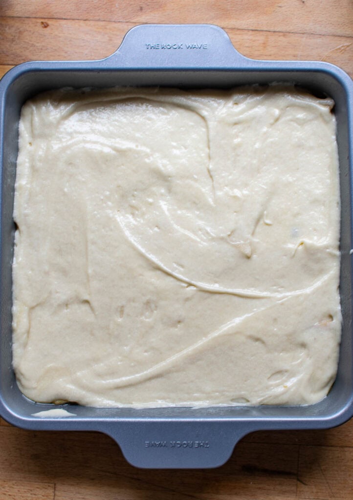 Cake batter spread over top of apple and walnut mixture to make upside down maple, apple and walnut cake.