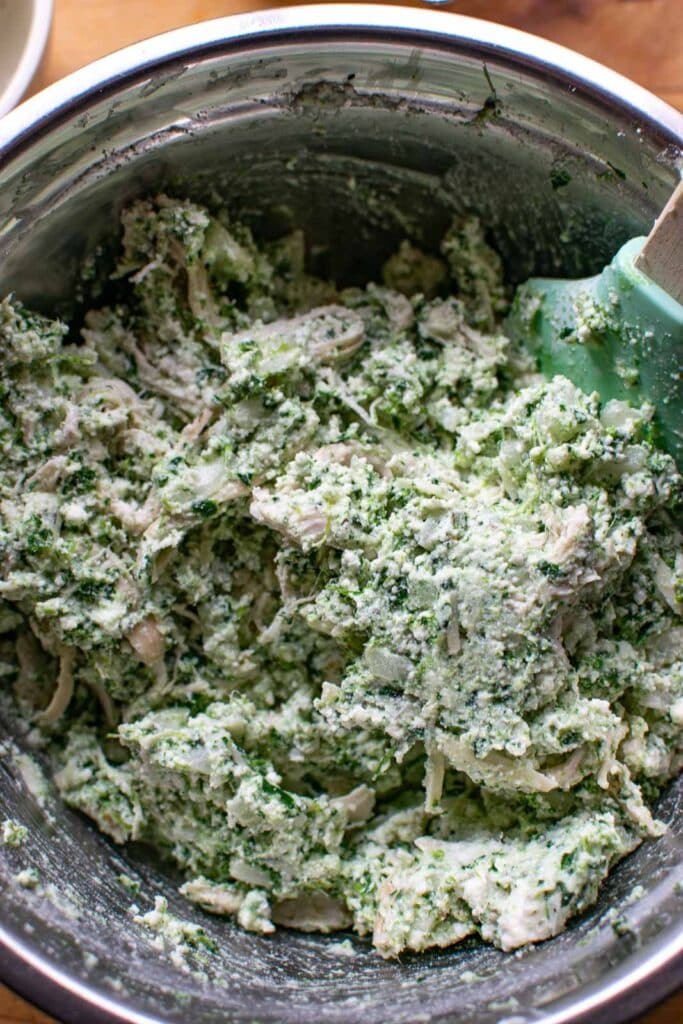 Shredded chicken added to the spinach and cheese mixture for chicken and spinach manicotti.