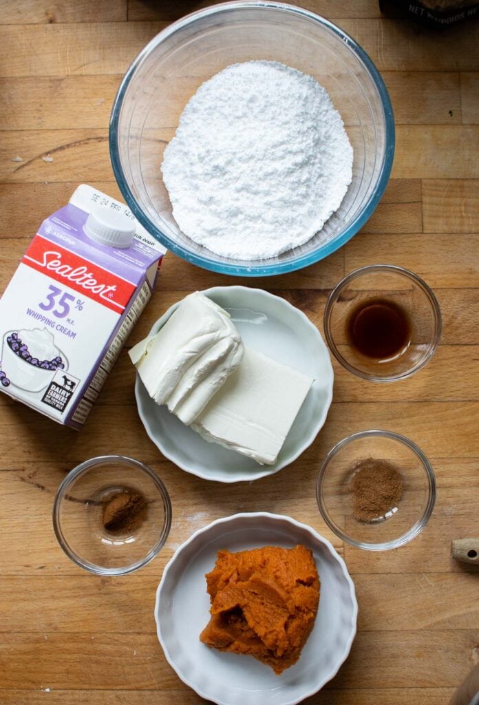 Ingredients to make pumpkin mousse including cream cheese and whipping cream.