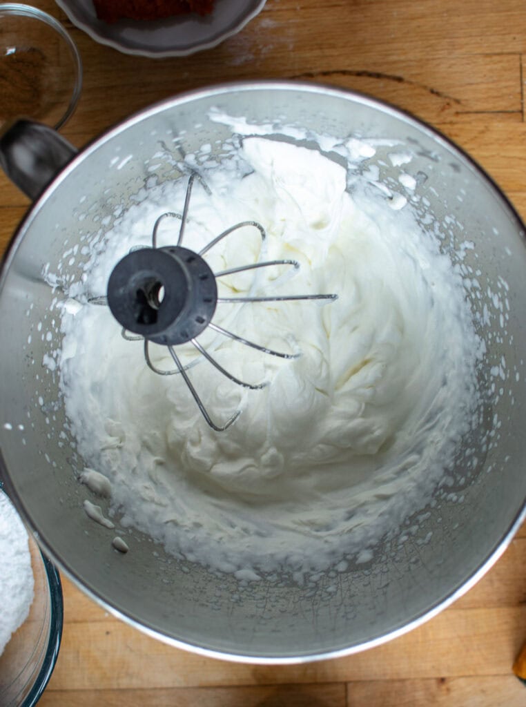 fresh whipped cream in the bowl of electric mixer with whisk attachment.