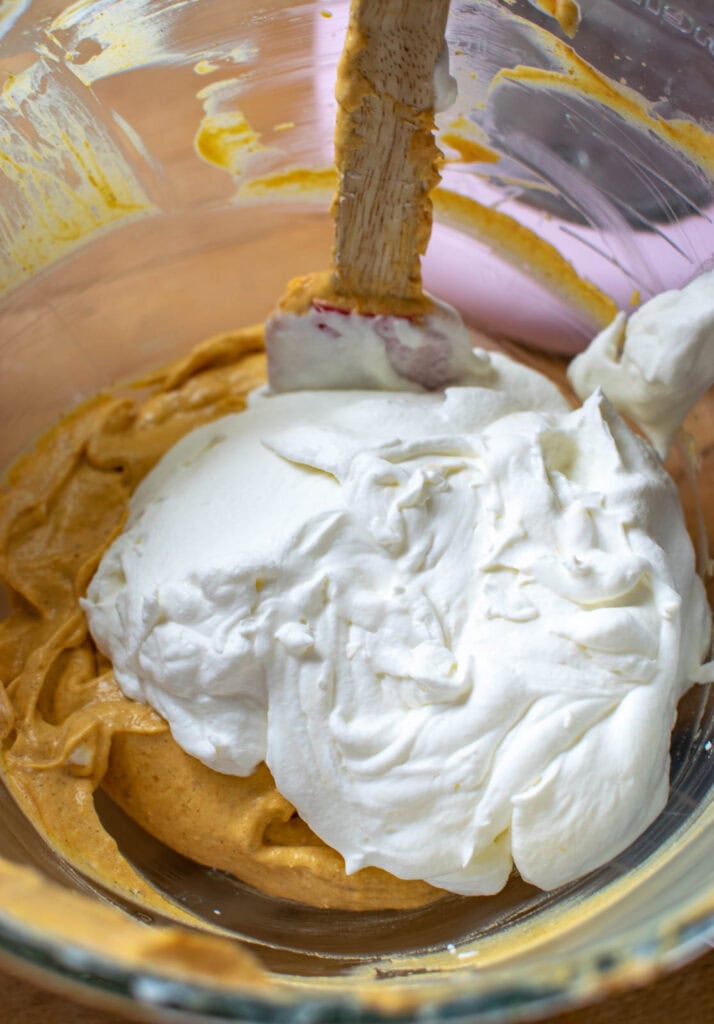 Fresh whipped cream add to mixing bowl with pumpkin cream cheese mixture.