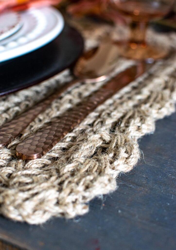 Chunky knit natural placemats for fall. Cooper flatware sit on top.