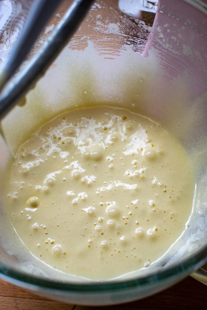 Eggs and sugar that have been beaten together in a stand mixer.