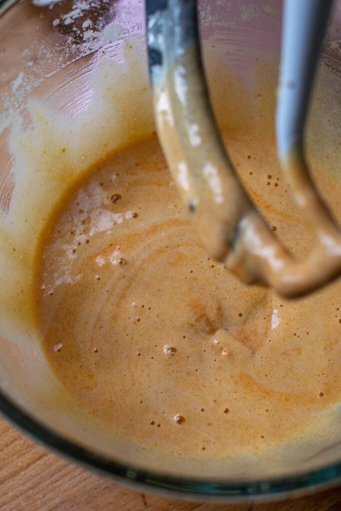 Pumpkin puree stirred into the egg and sugar mixture.