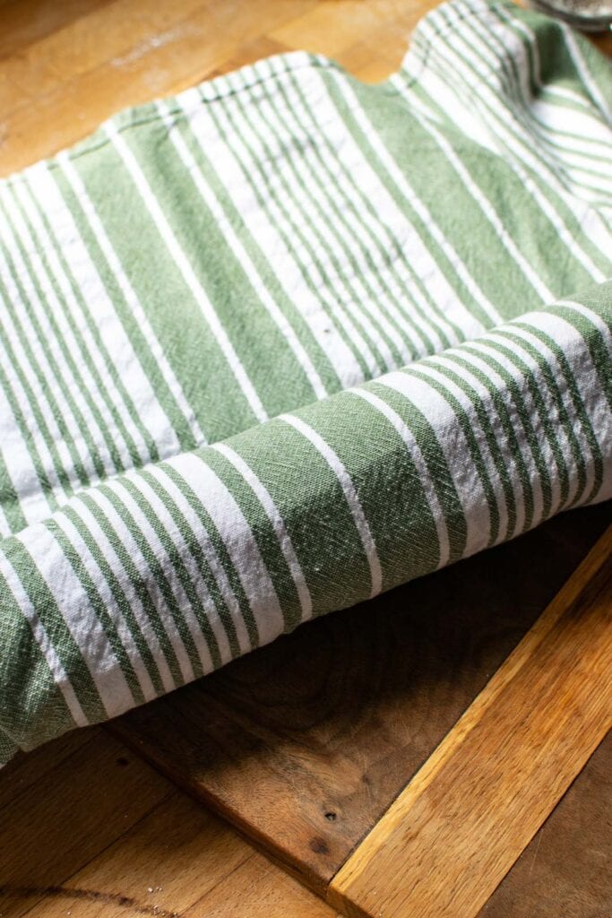 Sponge cake rolled in a clean kitchen towel while cooling.