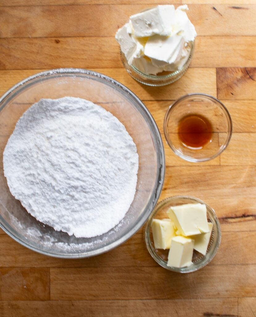 Ingredients to make a cream cheese filling for a pumpkin roll cake.