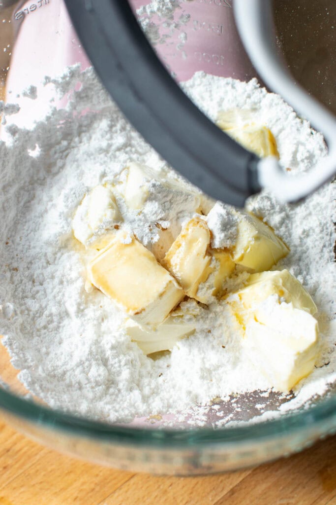 Ingredients to make cream cheese filling in a stand mixer.