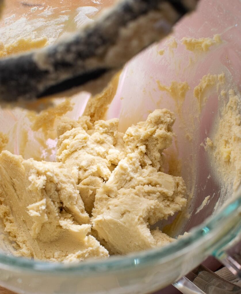 Dough for shortbread cutout cookies in the bowl of a stand  mixer.