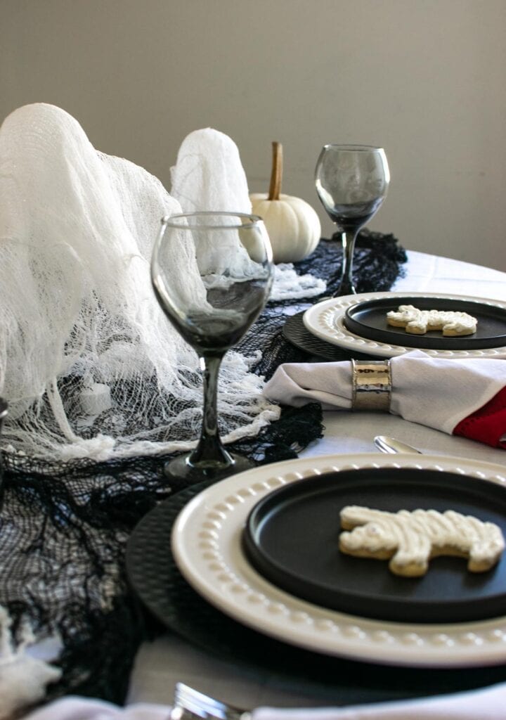 3 Ghosts made from cheesecloth as a centrepiece on a Halloween table.