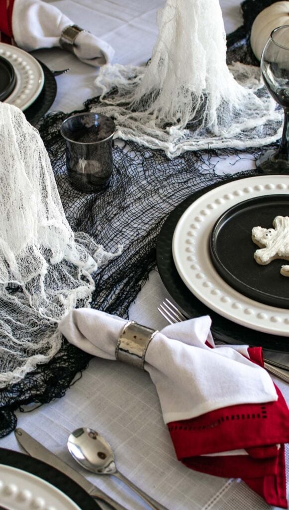 A ghost themed Halloween table all in black and white.