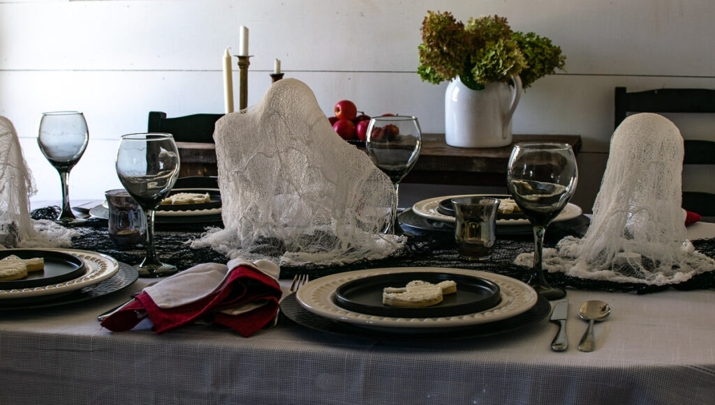 A large cheesecloth ghost in the centre of a Halloween Tablescape.
