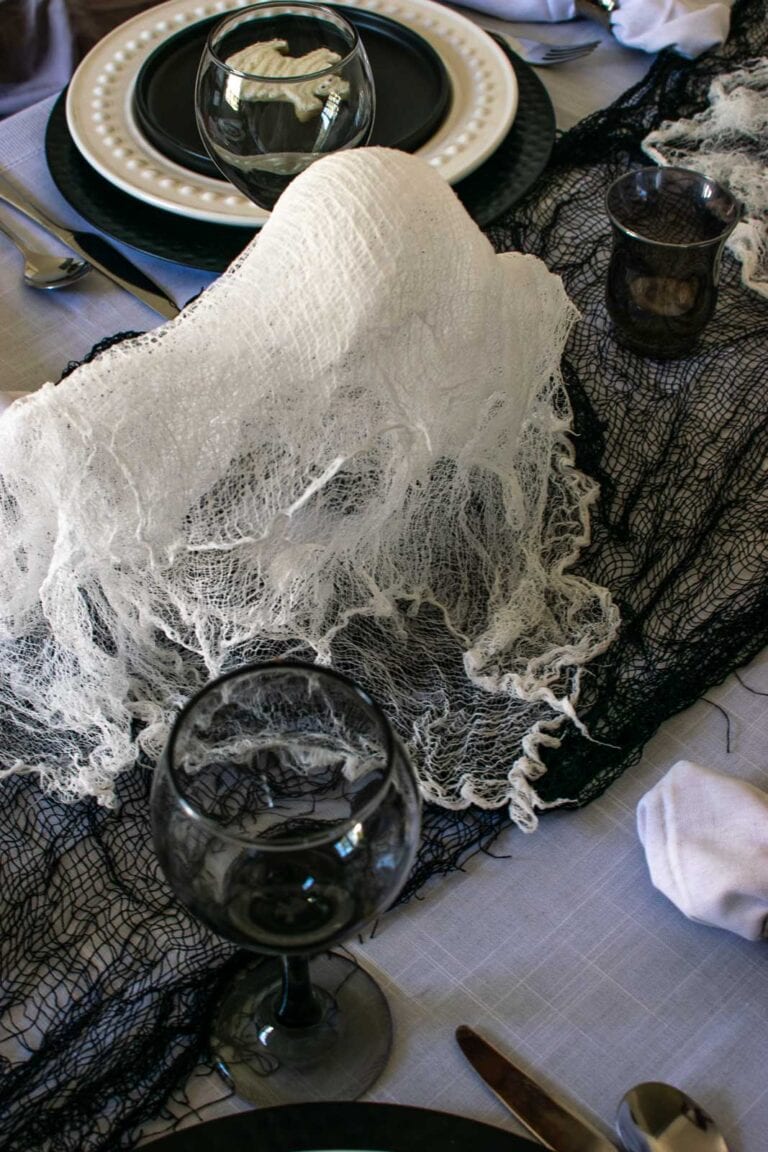A ghost made with cheesecloth as a centrepiece on a Halloween Table