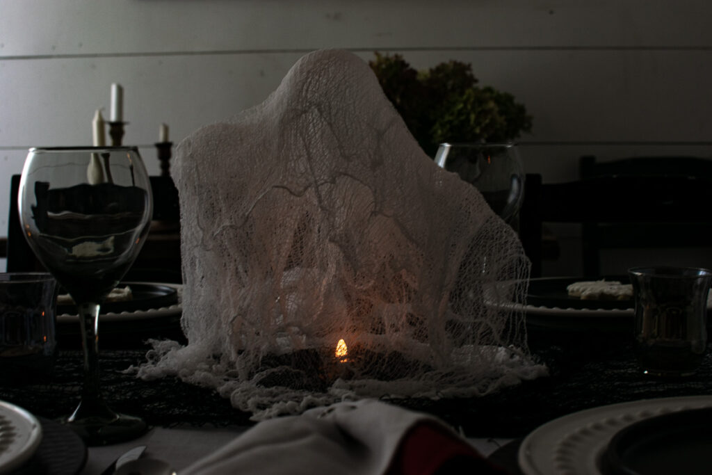 Cheesecloth ghosts with battery operated tea light candles lit up underneath.
