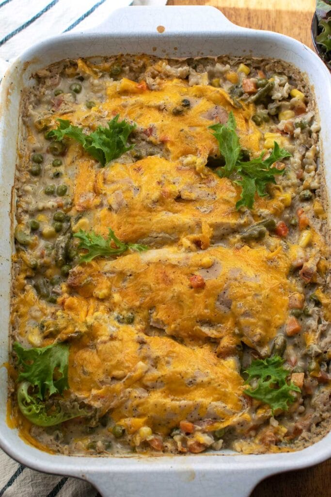 Old fashioned chicken and rice casserole topped with cheese and baked until bubbling.
