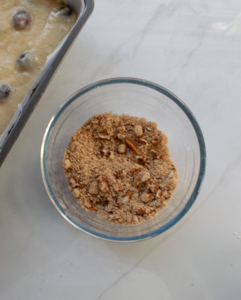 A crumble made of brown sugar, pecans and cinnamon to add on top of applesauce bread.