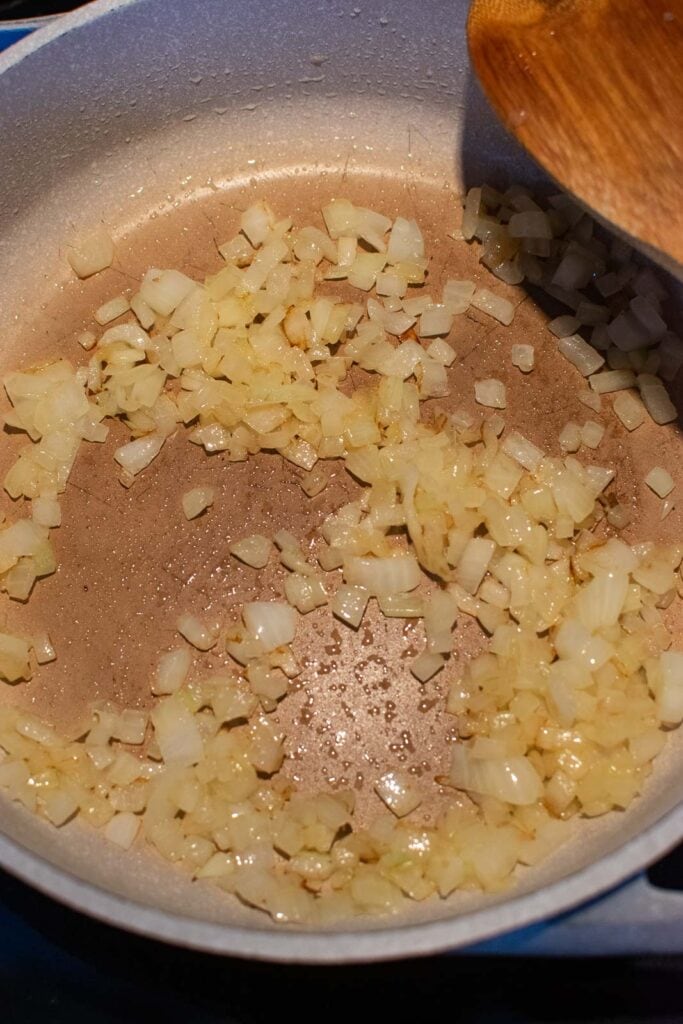 Onions frying in olive oil to make meatless sloppy joes.