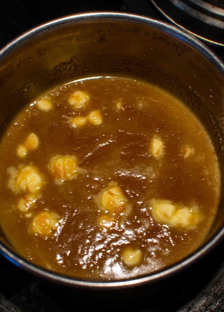 Butter and brown sugar in a saucepan on the stove top, starting to melt and blend together.