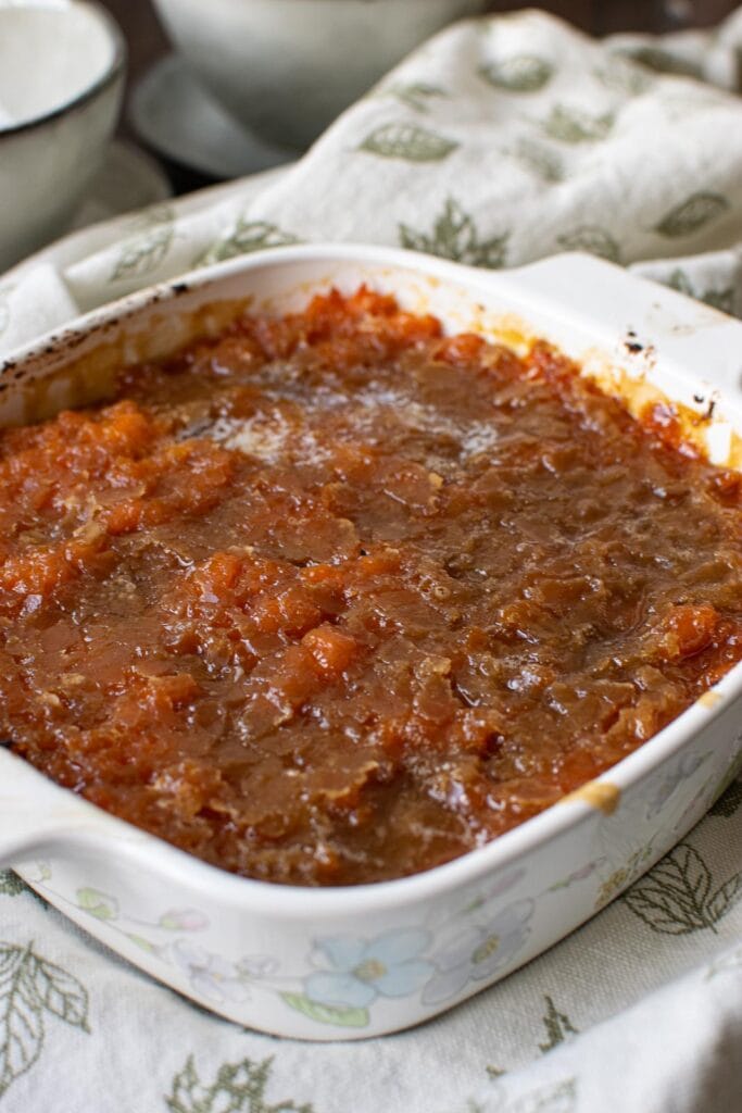 Brown sugar butter sweet potatoes in a white casserole dish.