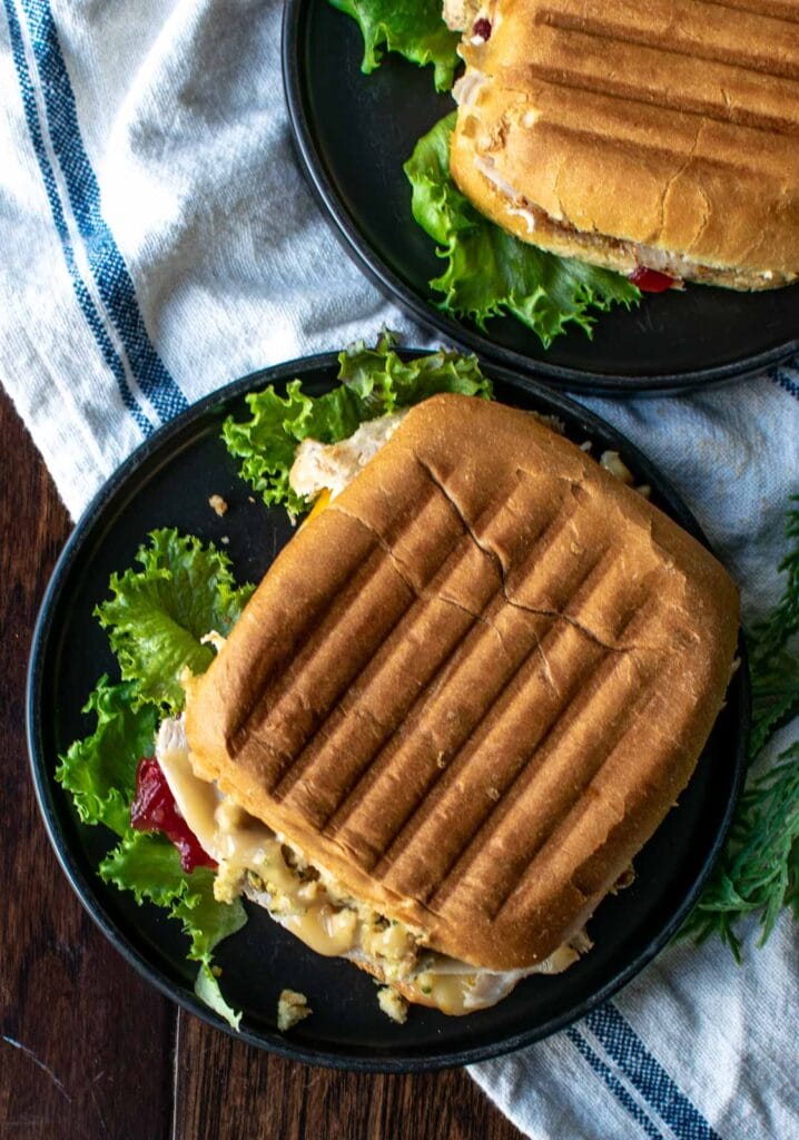 A turkey sandwich made on a square panini bun that has been heated in a sandwich press.