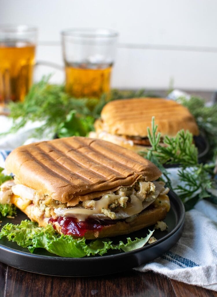 A grilled turkey and stuffing sandwich made on a panini bun, and pressed on a sandwich press to heat.