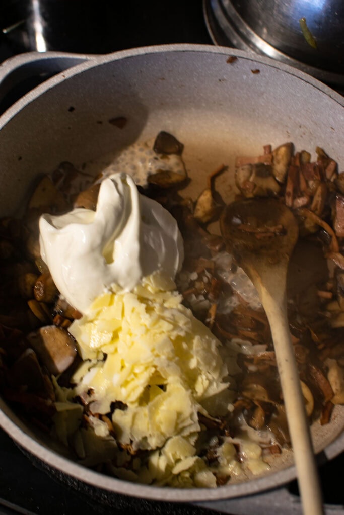 Sour cream, shaved parmesan cheese and cream added to the mushroom, bacon and onion mixture.