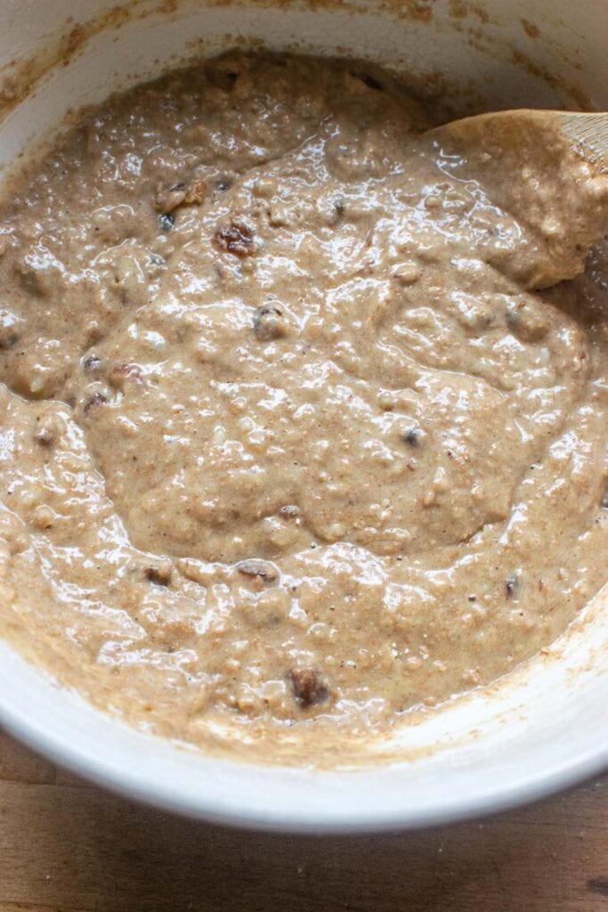 Batter to make mincemeat muffins in a large ceramic mixing bowl.