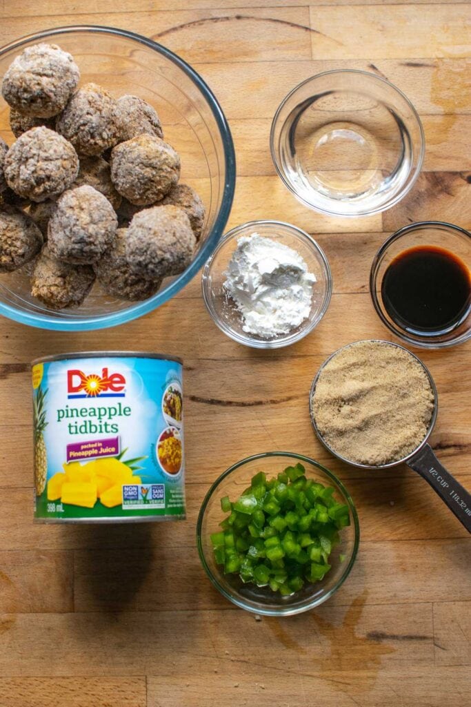 Ingredients to make sweet and sour meatballs including pineapple, brown sugar and soya sauce.