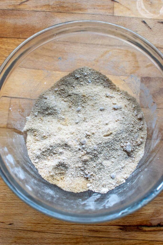 Corn starch and brown sugar mixed together in a glass mixing bowl.