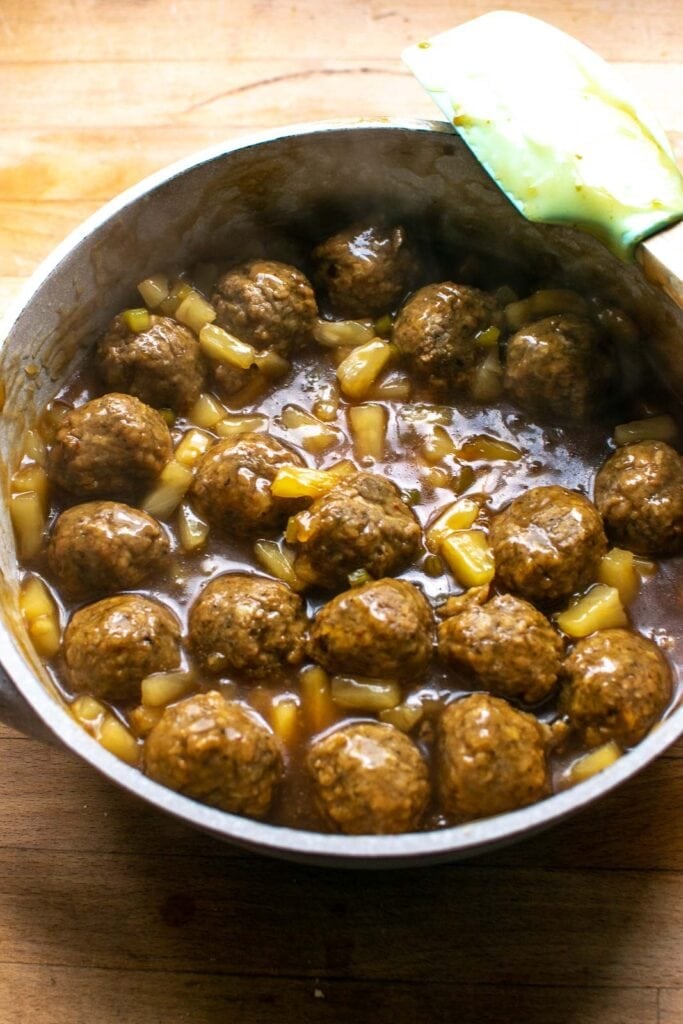 Completet sweet and sour meatballs that have been heated through with the sauce, pineapple and green pepper.