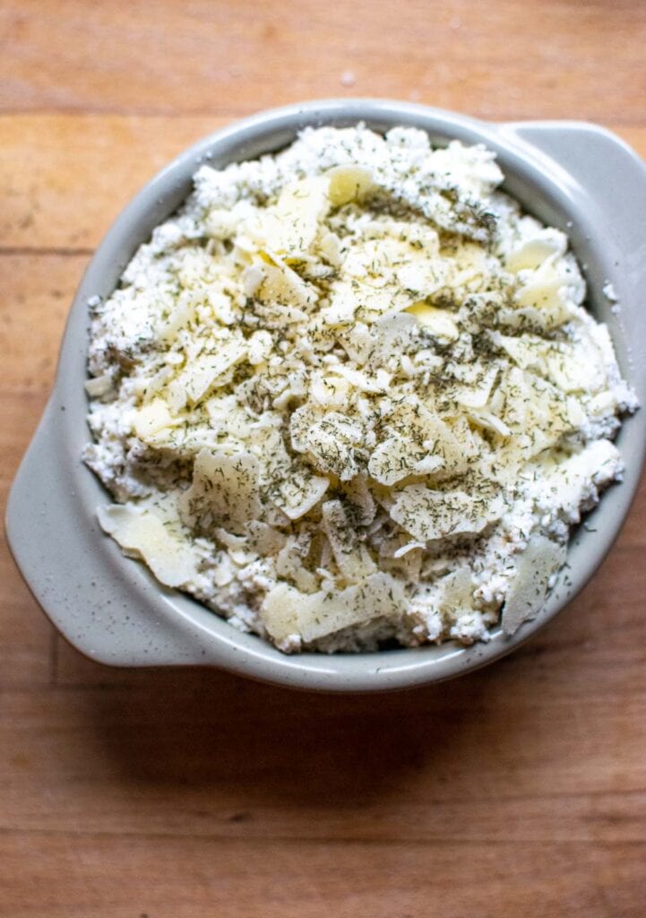 Ricotta and dill mixture topped with shaved parmesan and a sprinkle of dried dill and fresh black pepper.