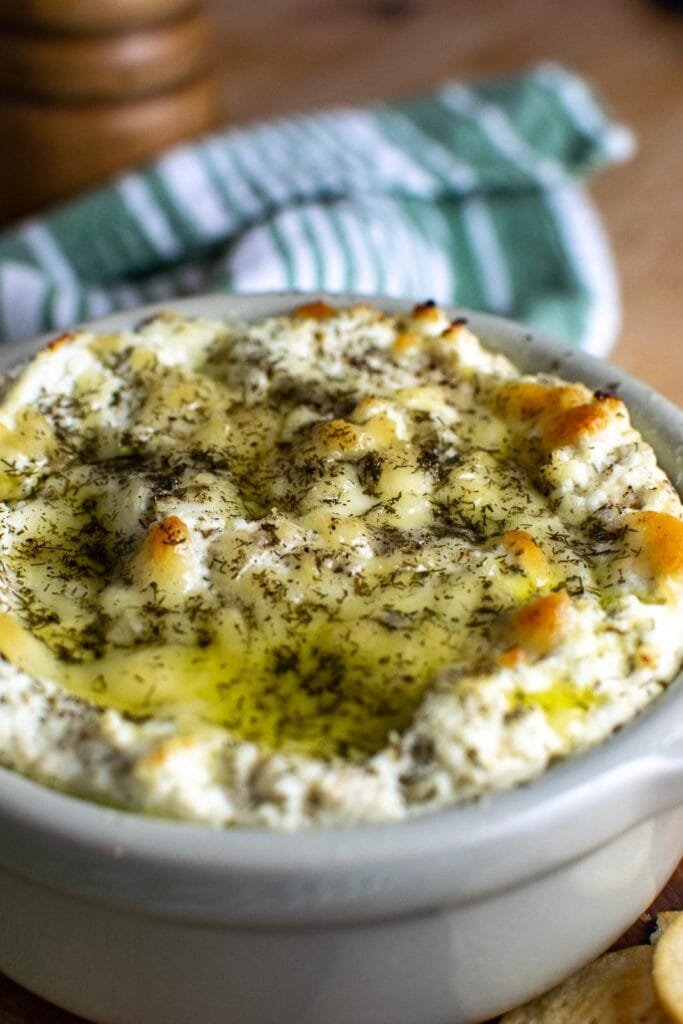 Baked ricotta dip with lemon and dill, drizzled with olive oil.