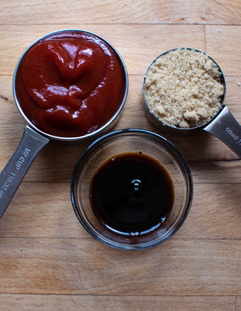 Ingredients to make a glaze for meatloaf, including ketchup, brown sugar and balsamic vinegar.