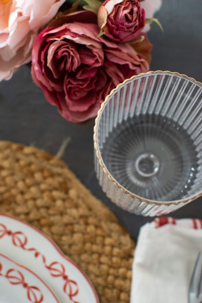 Looking down on an empty gold rimmed water glass.