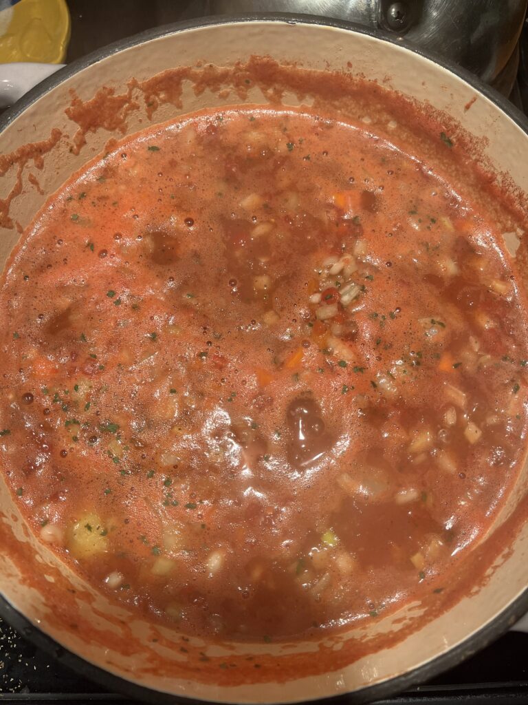 Pinto beans and navy beans in a cast iron dutch oven simmering over low heat for one hour.