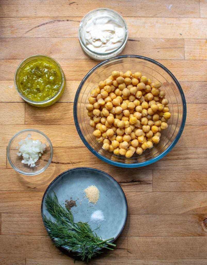 Ingredients to make chickpea salad for sandwiches including chick peas, dill relish, Miracle Whip, and chopped onion