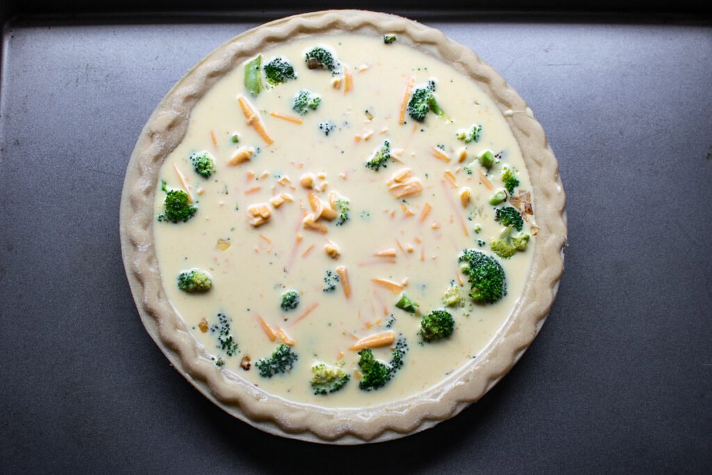 Egg, cream and cheese mixture poured over broccoli in an unbaked pie shell.