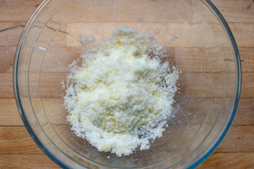 Fresh lemon rind that has been rubbed into granulated sugar to make lemon sugar.