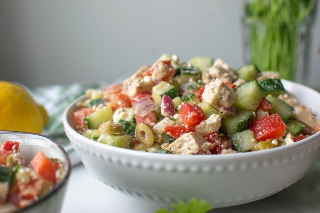 A large serving bowl filled with mediterranean salad.