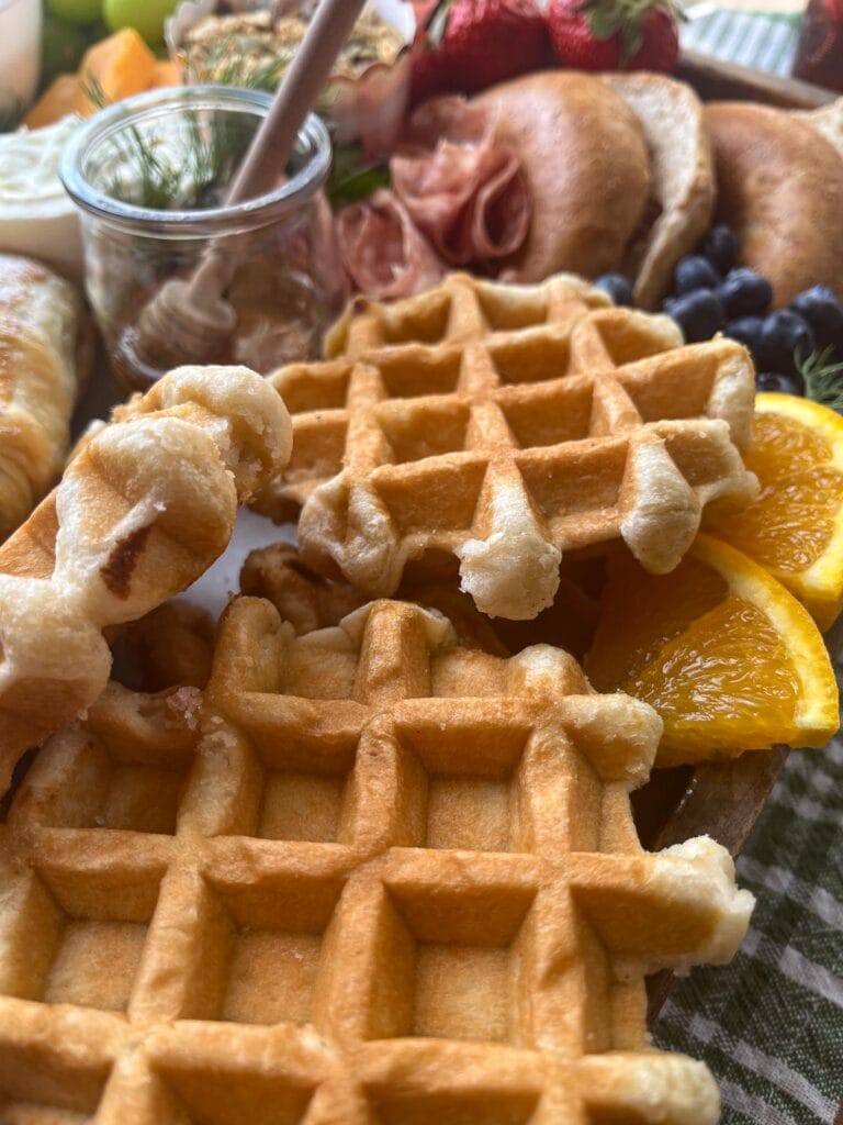 Mini Belgian waffles arranged on a brunch board for spring.