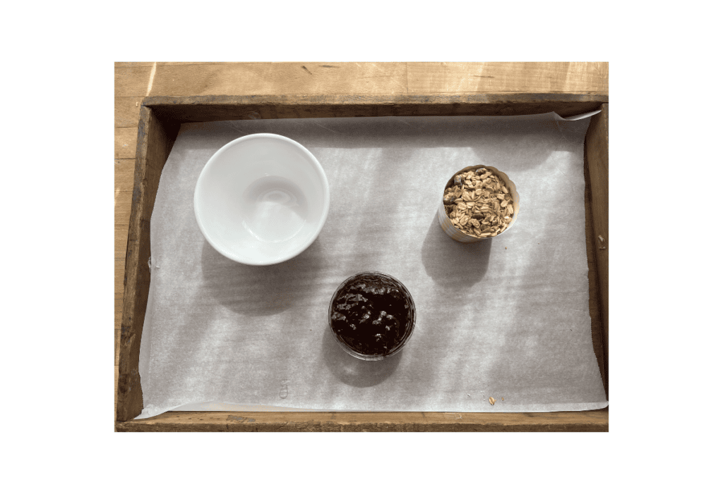 Step one of making a charcuterie board, start by placing any bowls for dips, nuts, etc. on the board.