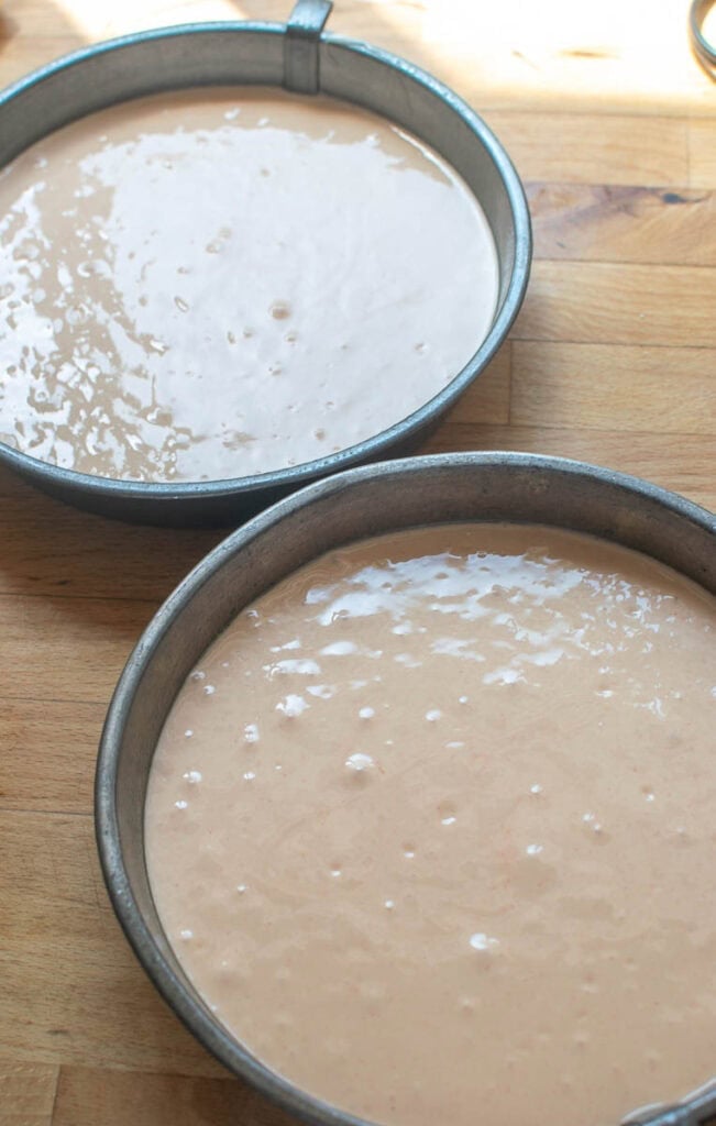 Watermelon cake batter in 8 inch round cake pans.