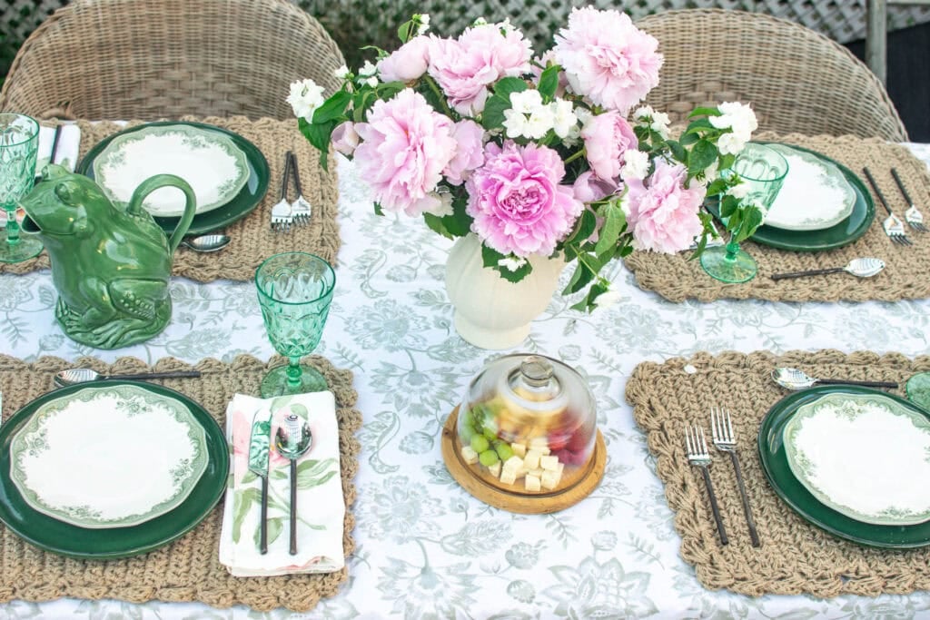 An outdoor summer dinner table set for four.