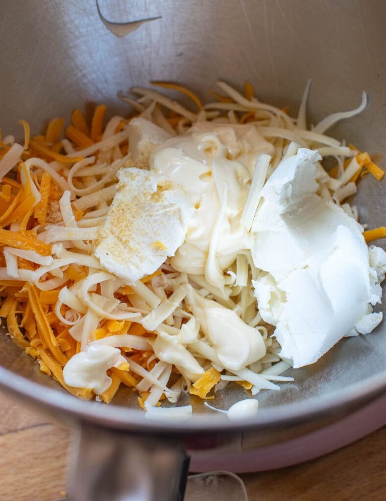 Ingredients for Pimento Cheese spread in the bowl of electric stand mixer before mixing.