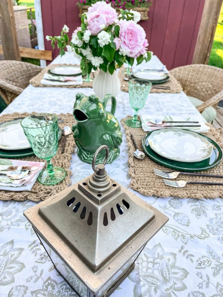 Summer tables cape set outside with green, pink and natural elements.