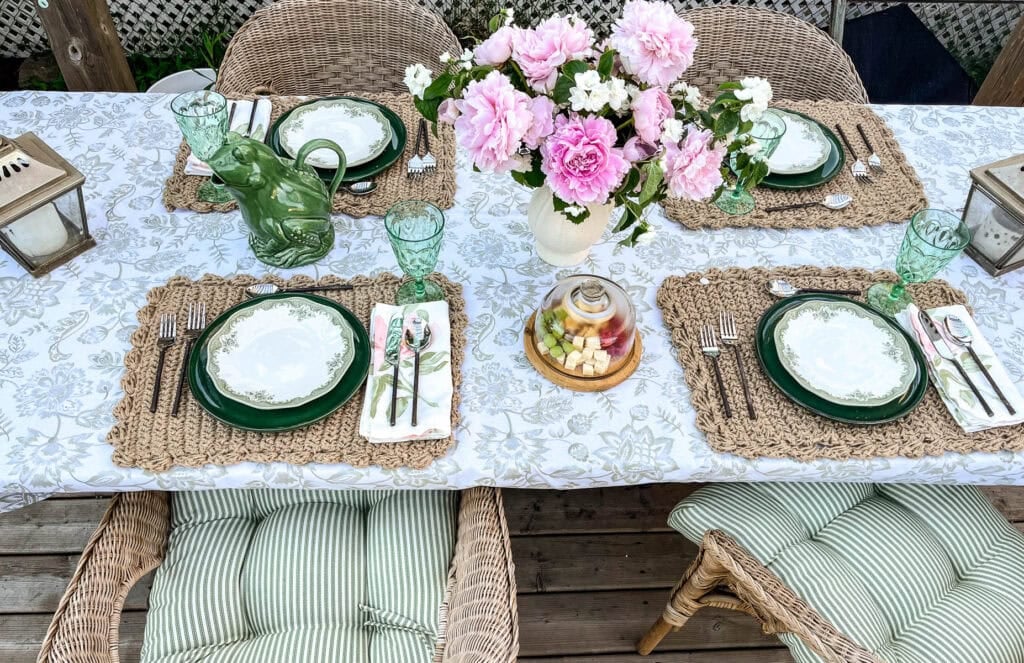 An overhead view of a table set for a summer dinner in the garden.