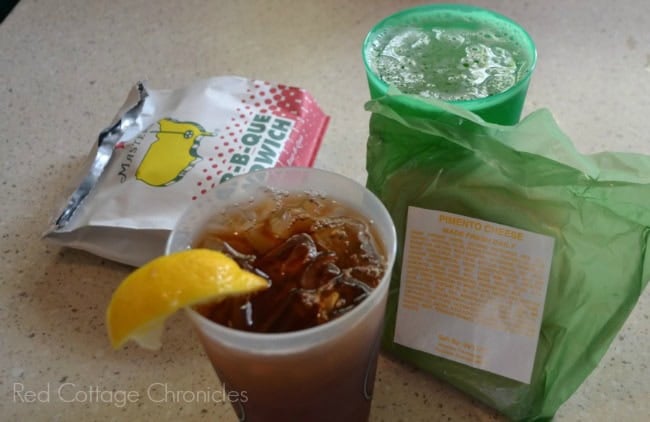 A pimento cheese sandwich, chicken sandwich and glass of Cola garnished with a lemon served at the Master's Golf tournament.